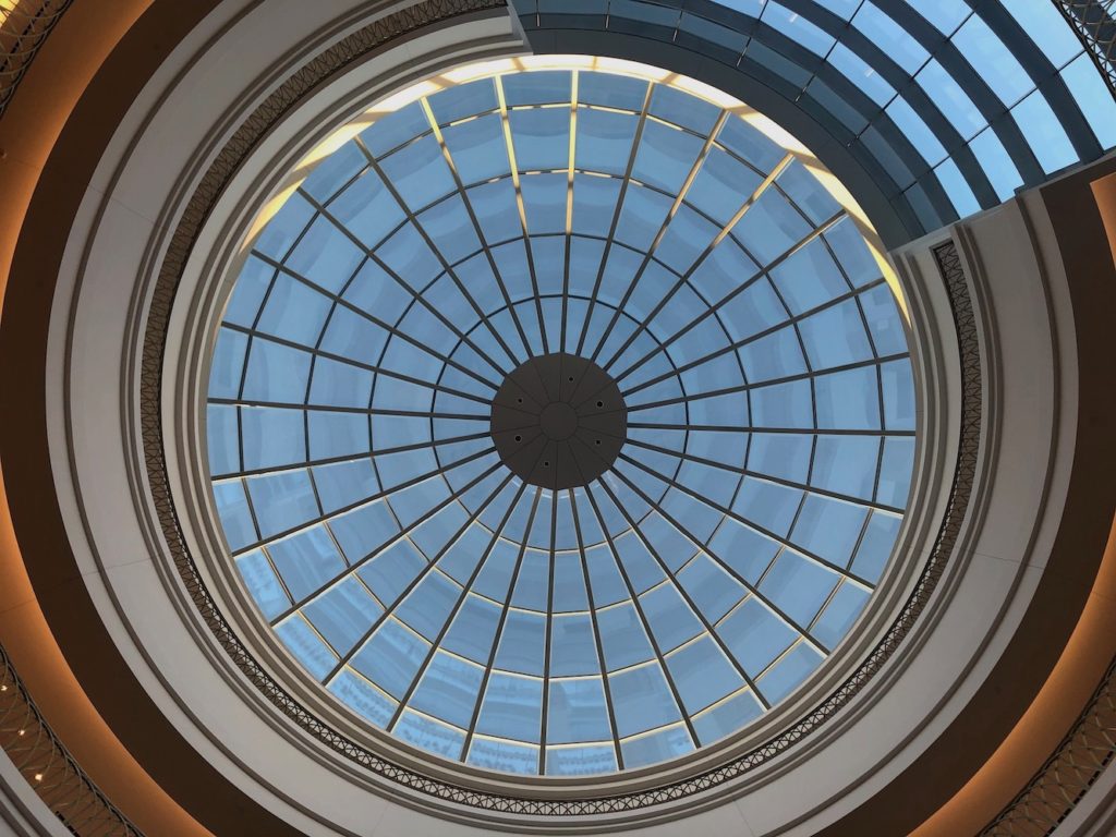 Looking up into the glass dome of a rotunda