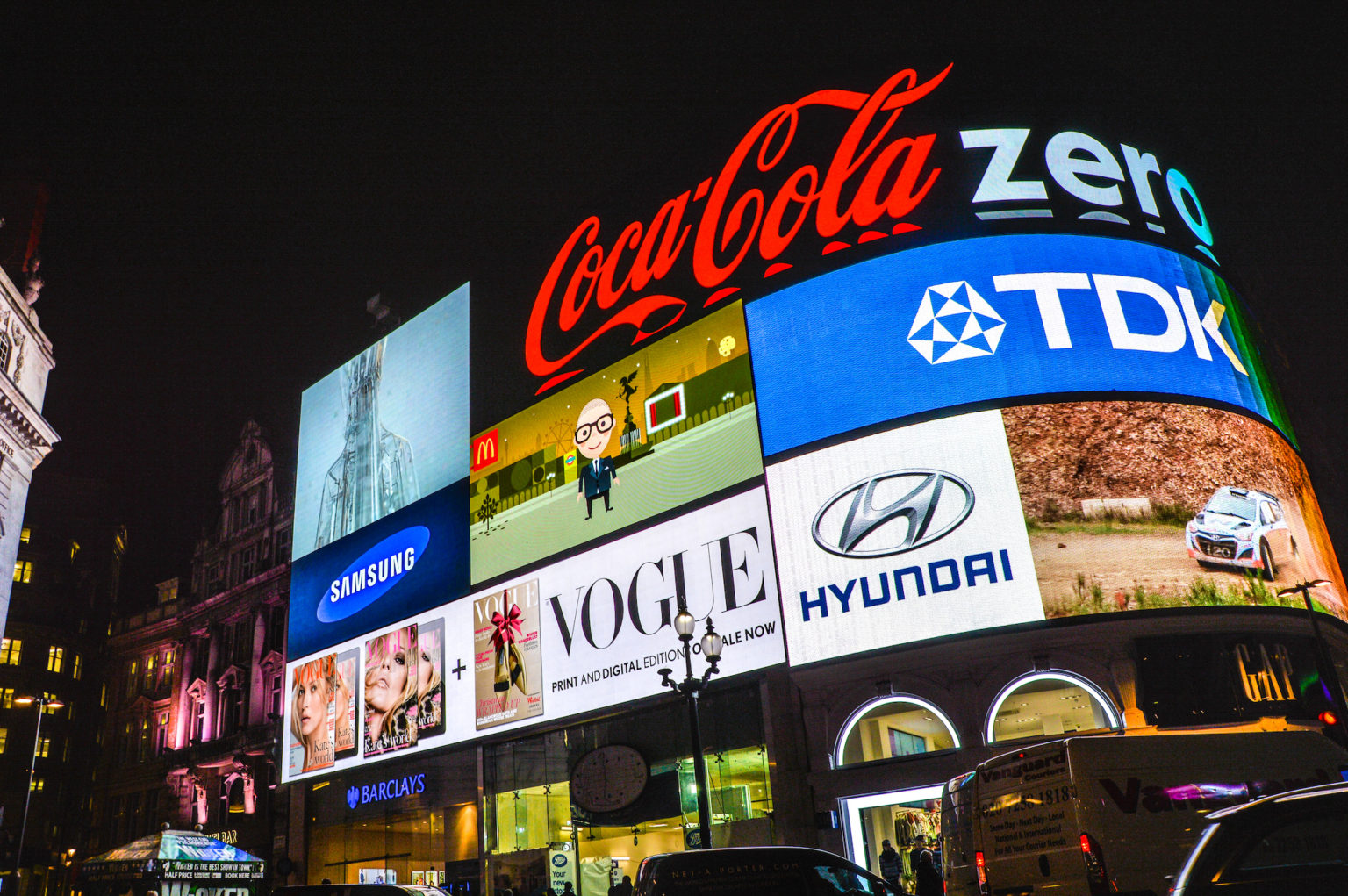Illuminated brand billboards at Piccadilly Circus in London at night