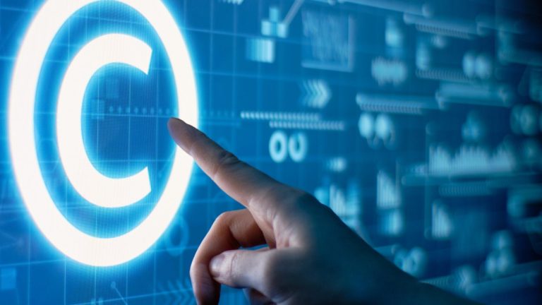 Hand touching a digital copyright symbol
