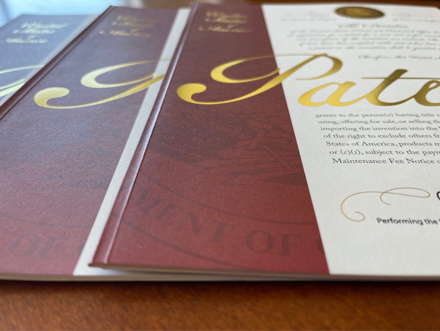 Issued United States patent grant covers with gold lettering